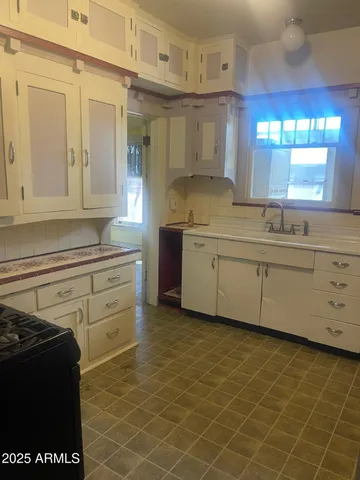 a kitchen with a sink cabinets and window