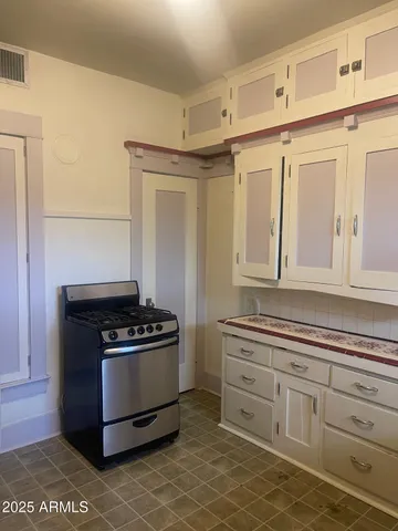 a kitchen with granite countertop a stove and a sink