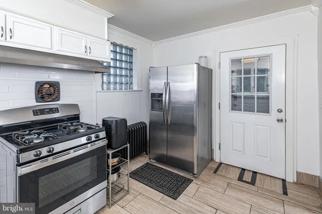 a kitchen with stainless steel appliances granite countertop a refrigerator and a stove