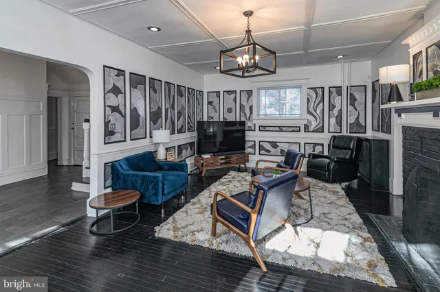 a living room with furniture and a chandelier