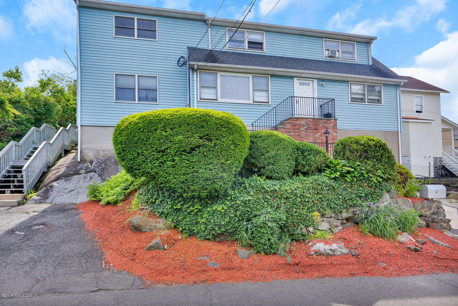 a front view of a house with garden