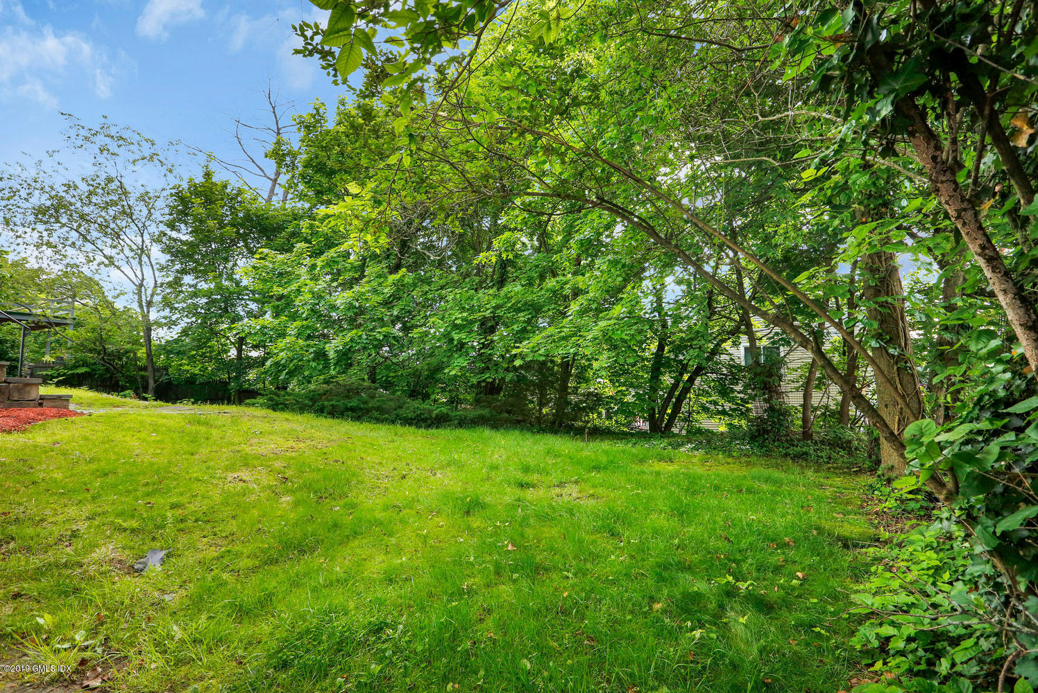 2 Booth Terrace Greenwich, CT 06830 - Photo 3 of 8 a view of a big yard with plants and large trees