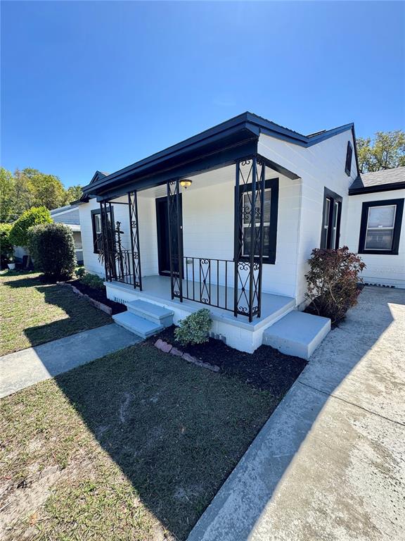 a view of a house with backyard porch and sitting area