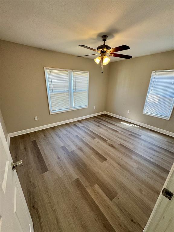 1912 West Grace Street Tampa, FL 33607 - Photo 11 of 22 wooden floor in an empty room with a window