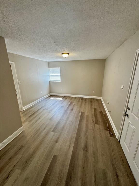 1912 West Grace Street Tampa, FL 33607 - Photo 18 of 22 wooden floor in an empty room with a window