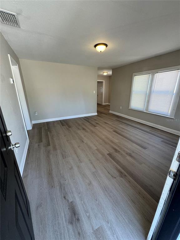 1912 West Grace Street Tampa, FL 33607 - Photo 6 of 22 wooden floor in an empty room with a window