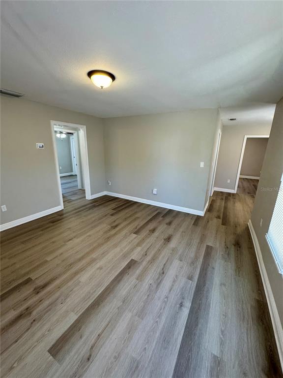 1912 West Grace Street Tampa, FL 33607 - Photo 7 of 22 a view of an empty room with wooden floor and a window