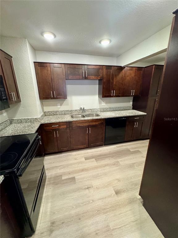 1912 West Grace Street Tampa, FL 33607 - Photo 8 of 22 a large kitchen with kitchen island granite countertop a sink and cabinets