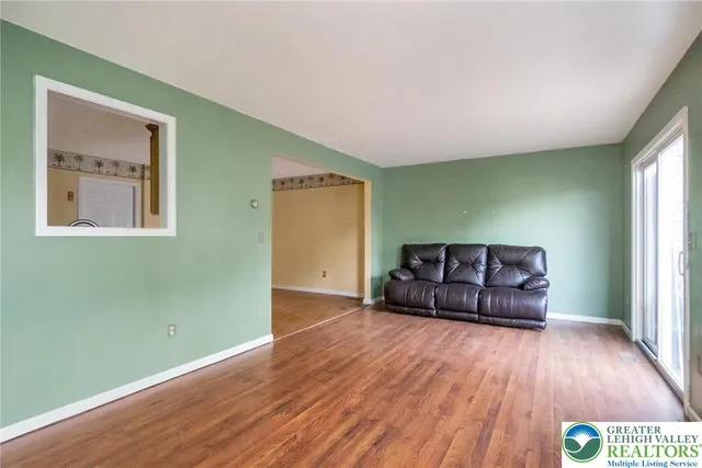 a living room with hard wood floors and a wooden floors