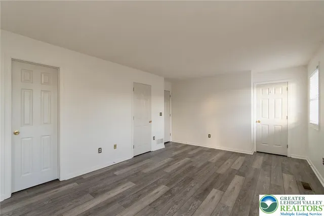 a view of an empty room and wooden floor