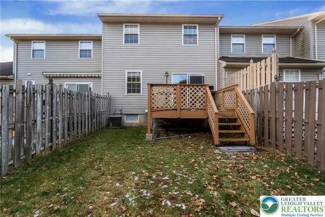 a view of a house with wooden fence