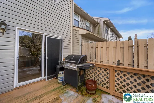 a view of a roof deck with wooden fence