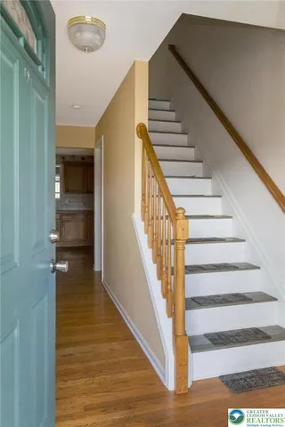 a view of entryway and hall with wooden floor