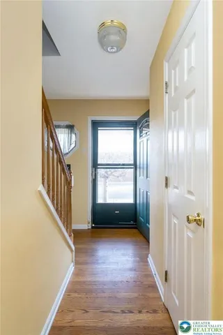 a view of an entryway with wooden floor