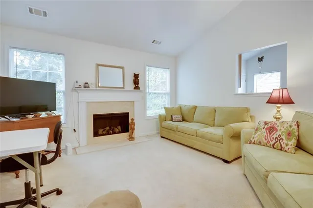 a living room with furniture a bed and a chandelier