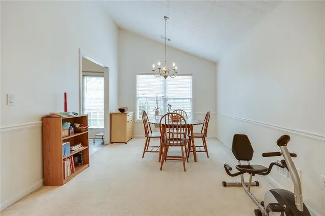 a view of a dining room with furniture and a chandelier
