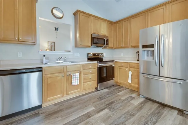 a view of kitchen with sink microwave and stove