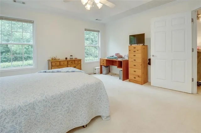 a bathroom with a sink a toilet a shower and a mirror