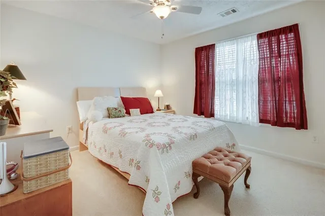 a bedroom with a bed and a large mirror