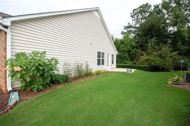 a view of an house with backyard space and garden