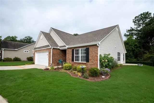 a sign that is sitting in front of flowers