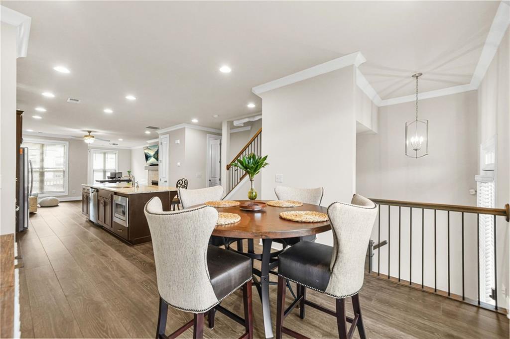 2207 Parkside Gln View Duluth, GA 30097 - Photo 13 of 41 a view of a dining room with furniture and wooden floor