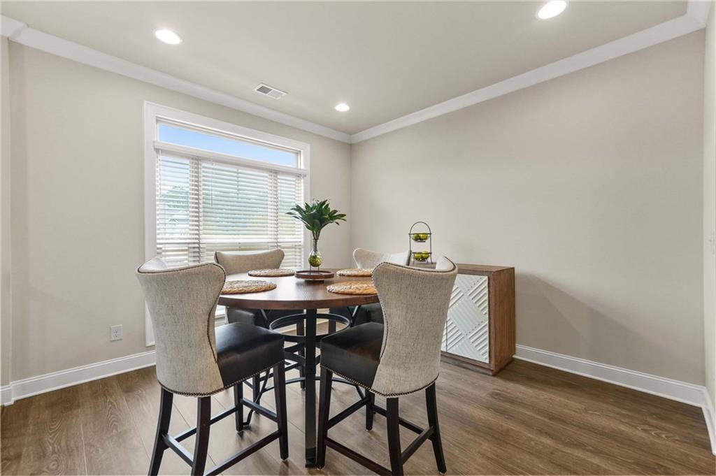 2207 Parkside Gln View Duluth, GA 30097 - Photo 14 of 41 a view of a dining room with furniture and wooden floor