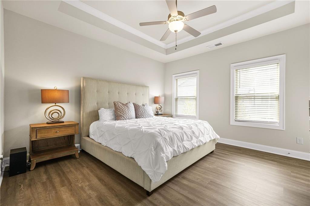 2207 Parkside Gln View Duluth, GA 30097 - Photo 18 of 41 a bedroom with bed and a chandelier