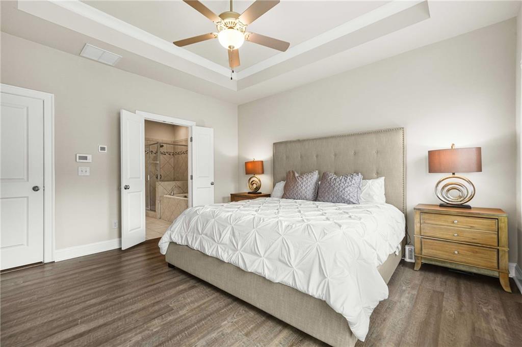 2207 Parkside Gln View Duluth, GA 30097 - Photo 19 of 41 a bedroom with a bed and a chandelier