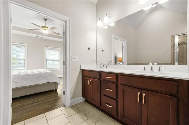 a en suite bathroom with a double vanity sink and a mirror