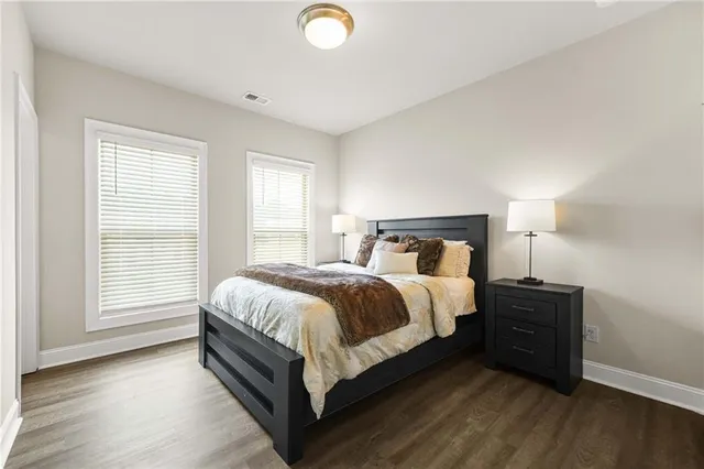 a bedroom with a bed and a lamp