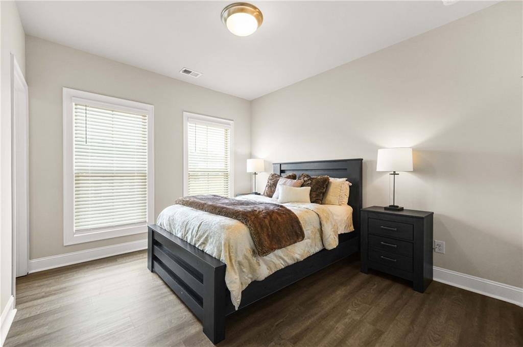 2207 Parkside Gln View Duluth, GA 30097 - Photo 24 of 41 a bedroom with a bed and a lamp