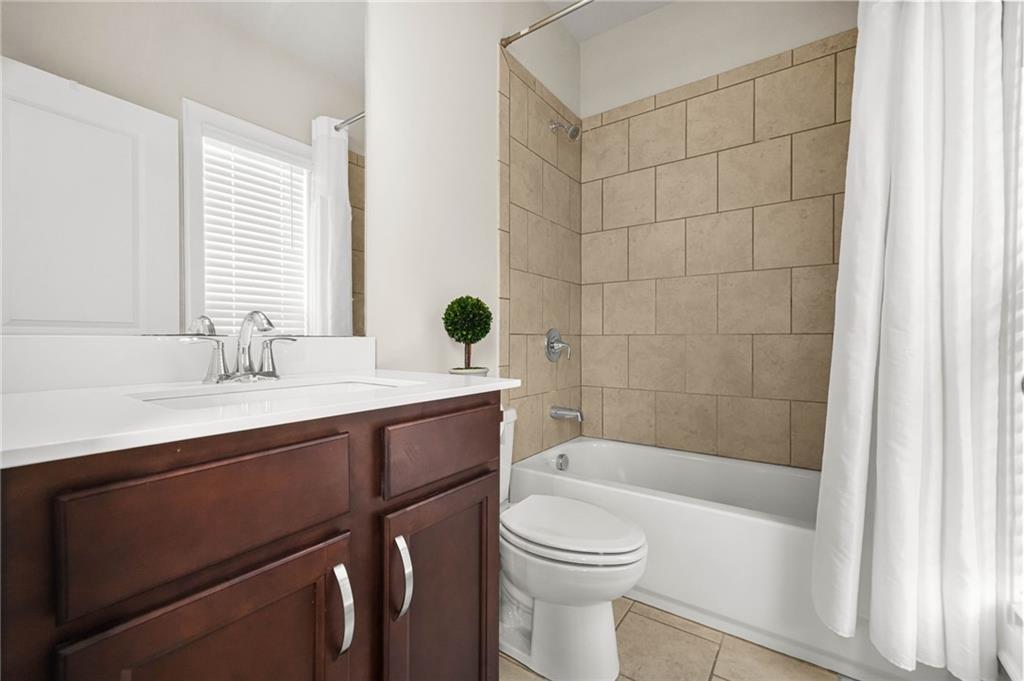 2207 Parkside Gln View Duluth, GA 30097 - Photo 26 of 41 a bathroom with a sink a toilet a mirror and shower