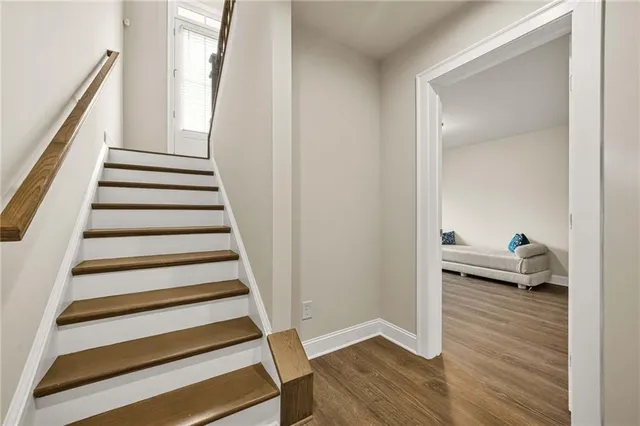 a view of entryway with wooden floor and stairs