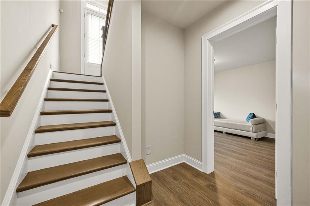 2207 Parkside Gln View Duluth, GA 30097 - Photo 32 of 41 a view of entryway with wooden floor and stairs