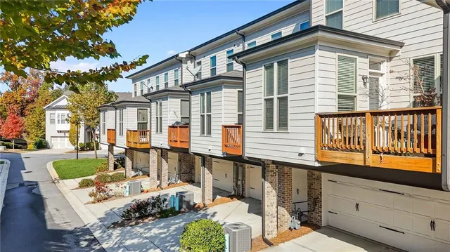 a view of a house with couches chairs and wooden floor