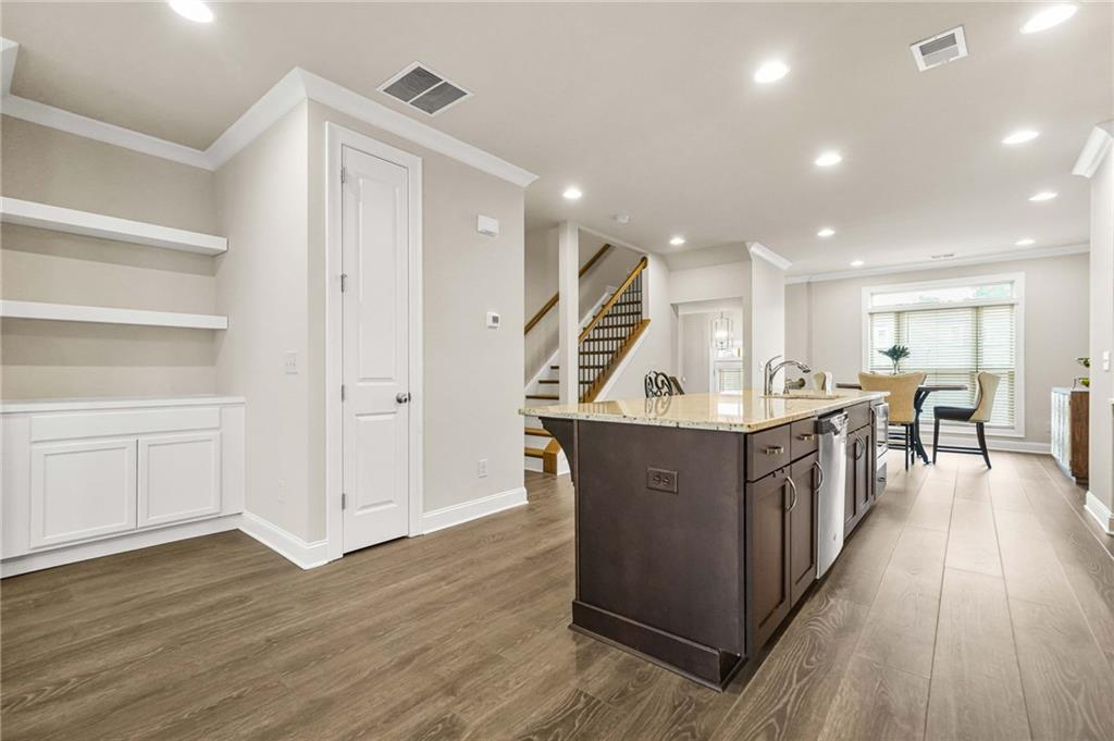 2207 Parkside Gln View Duluth, GA 30097 - Photo 7 of 41 a open kitchen with wooden floors and a sink