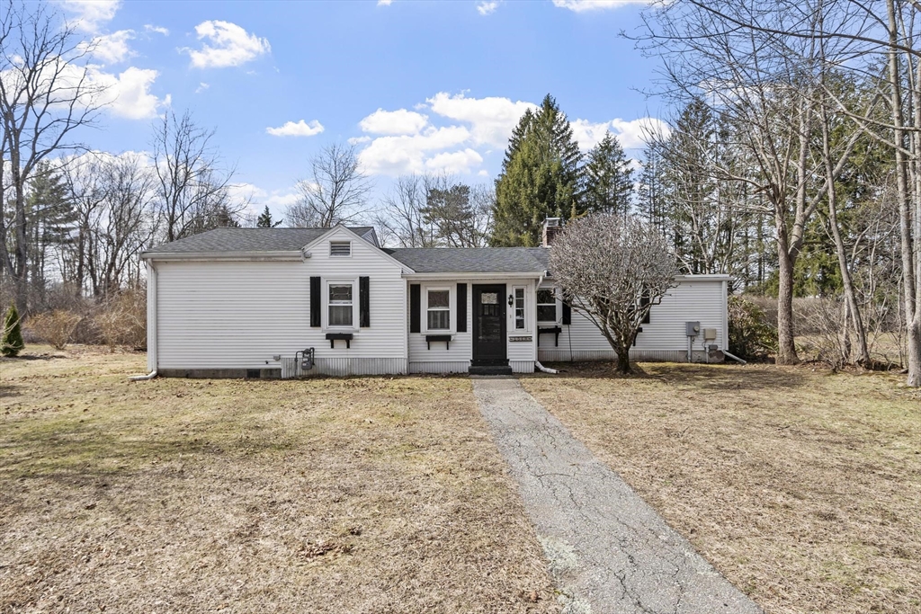 156 R North Street Medfield, MA 02052 - Photo 1 of 17 a front view of a house with a dirt yard and a garage
