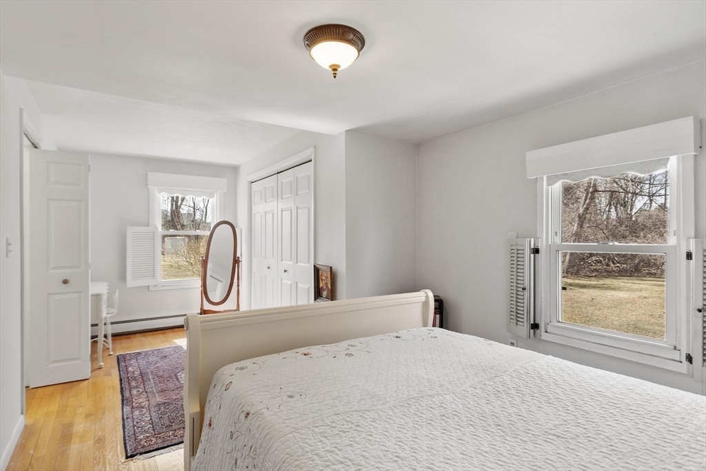 156 R North Street Medfield, MA 02052 - Photo 12 of 17 a bedroom with a bed and a chandelier