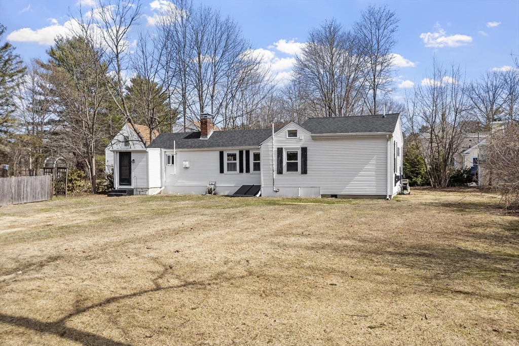 156 R North Street Medfield, MA 02052 - Photo 2 of 17 a front view of a house with a dirt yard and a large tree