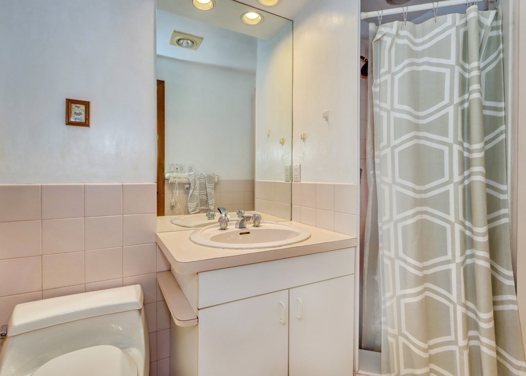 11 Viking Road Winchester, MA 01890 - Photo 18 of 41 a bathroom with a sink toilet and shower