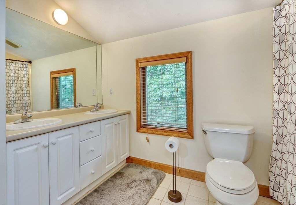 11 Viking Road Winchester, MA 01890 - Photo 25 of 41 a bathroom with a toilet sink and mirror