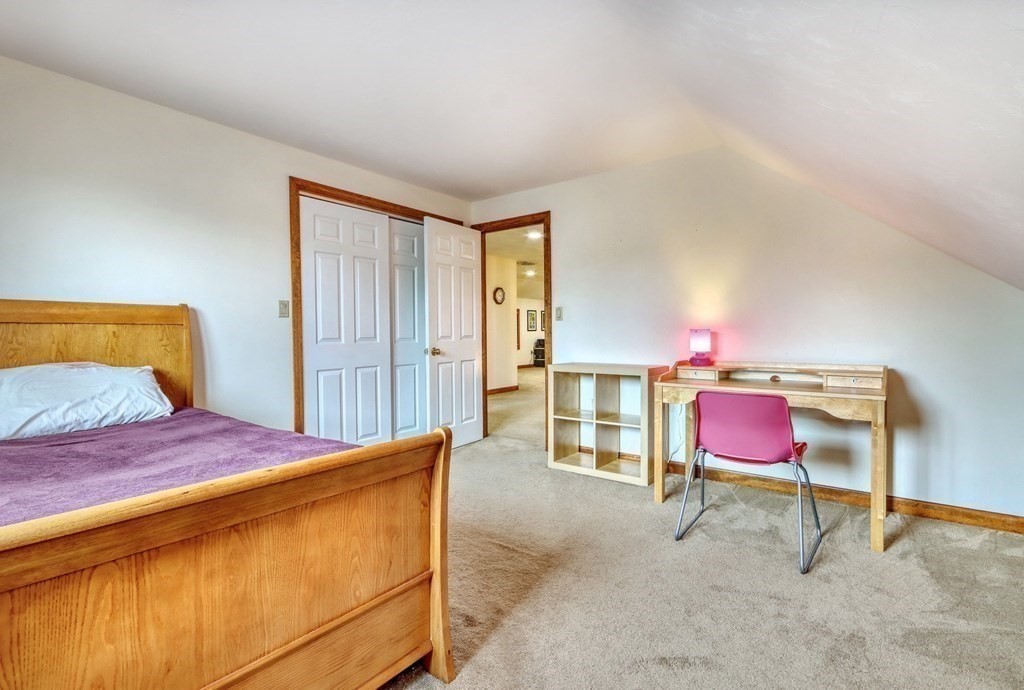 11 Viking Road Winchester, MA 01890 - Photo 27 of 41 a bedroom with a bed chair and a lamp on table