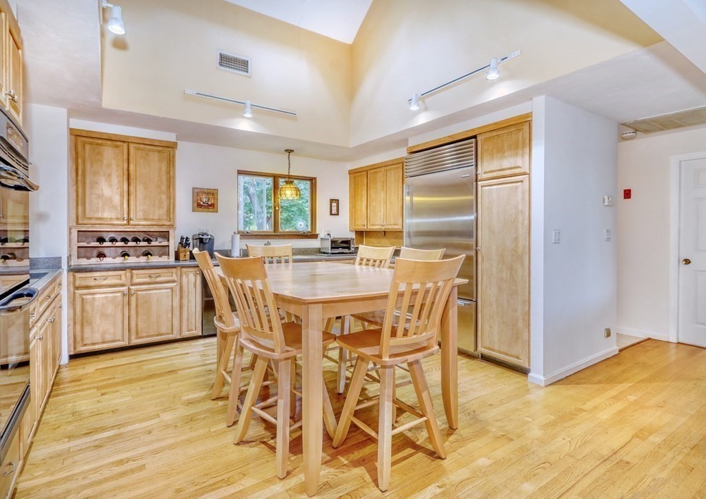 11 Viking Road Winchester, MA 01890 - Photo 7 of 41 a kitchen with stainless steel appliances kitchen island granite countertop a stove a refrigerator and white cabinets with wooden floor