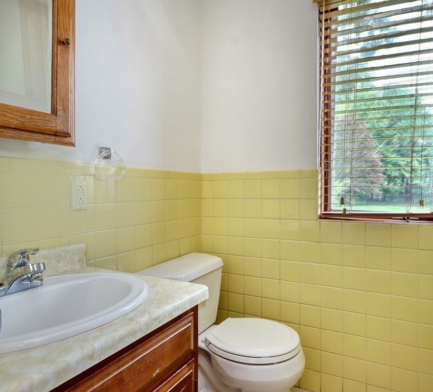 11 Viking Road Winchester, MA 01890 - Photo 9 of 41 a bathroom with a sink a toilet and a mirror