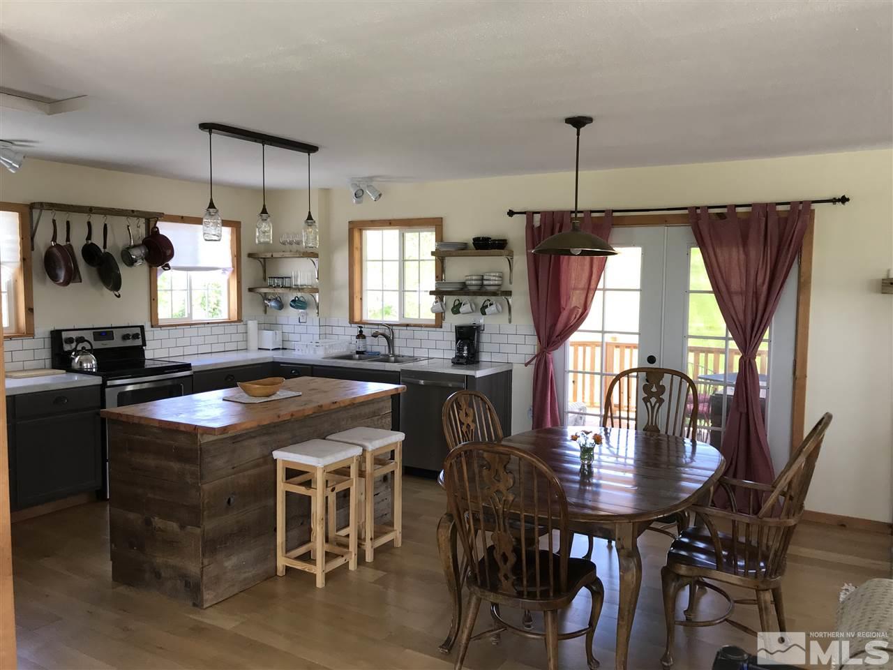 4045 Fairview Road Reno, NV 89511 - Photo 18 of 24 a kitchen with granite countertop a table chairs a sink dishwasher window and cabinets