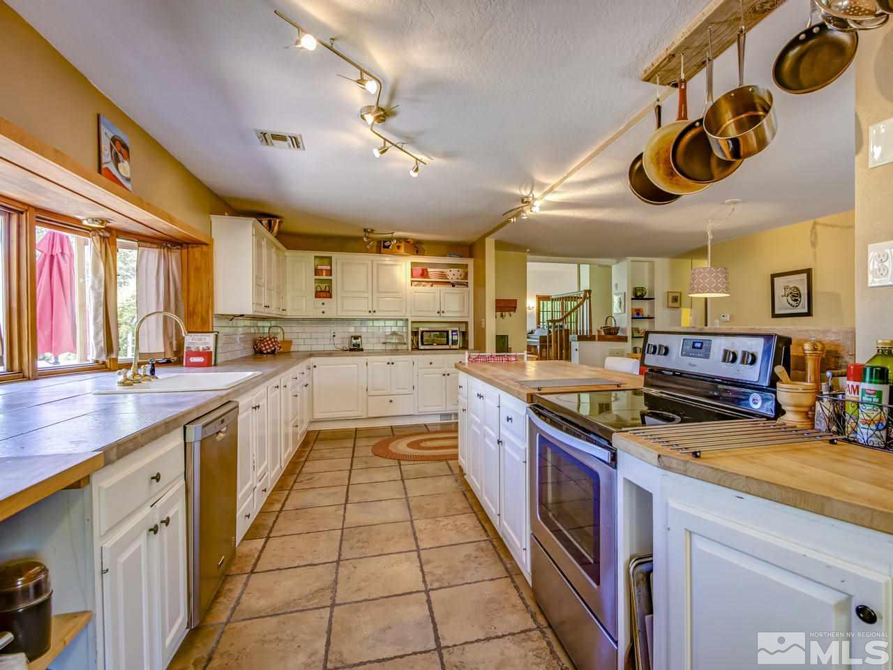 4045 Fairview Road Reno, NV 89511 - Photo 8 of 24 a large kitchen with stainless steel appliances lots of counter space cabinets a sink and a large window