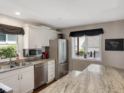 a kitchen with stainless steel appliances a refrigerator sink and microwave