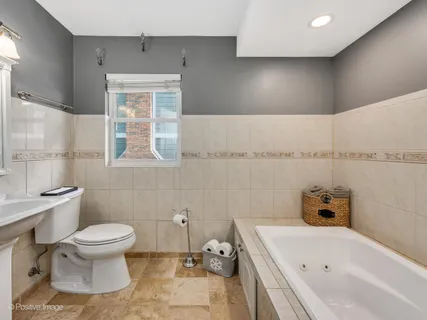 a bathroom with a bathtub sink and toilet