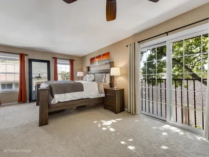 a bedroom with furniture and a large window